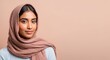 © Postmodern Studio - Young asian female wearing pink hijab on beige background