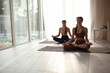 © Вероника Зеленина - Two young girl are practicing yoga indoor. people wear top and comfortable leggins,embodying a snse of pease.together they create a harmonious atmosphere, showcasting the beauty and benefits of yoga