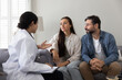© fizkes - Serious young couple visiting female doctor, consulting about healthcare problems, consulting medical professional, discussing recommendation, treatment, diagnosis