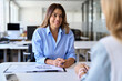 © insta_photos - Happy middle aged business woman financial advisor, bank manager consulting client working in corporate office. Smiling professional female hr having job interview meeting with recruit.