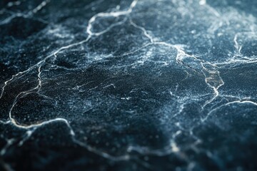 Leinwandbilder - Close-up view of a dark, textured surface with a network of fine cracks and crevices.