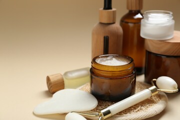 Wall Mural - different body care products and massaging tools on beige background, closeup. space for text