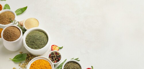 Wall Mural - Bowls with different spices on light background with space for text