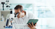 © HockleyM4/peopleimages.com - Man, microscope and tablet for results with science for medical study with container, review and space. Person, digital touchscreen and app for chemical analysis with pharma for vaccine development