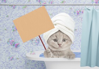 Leinwandbilder - Cute kitten with towel on it head takes the bath at home with rubber duck and showing blank placard. Empty space for text