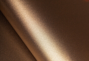 Aufkleber - Warm gold and bronze paper background with a glossy, pearlescent texture and shimmering glitter effect. The reflective light and shadow create an elegant, luxurious design with a sleek, abstract.