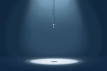 Wall Mural - Minimalistic lighting design featuring a reflective drop suspended above a spotlight area creating a calm atmosphere