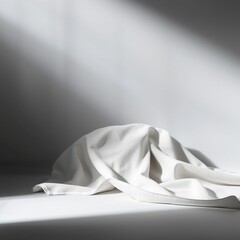 Wall Mural - Soft white fabric draped on a surface illuminated by gentle light creating a serene minimalist effect
