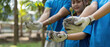 © Natee Meepian - Environmental Stewardship and Team Spirit. Young volunteers showcasing their saplings for planting.