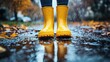 © ezen - Yellow boots reflecting in autumn rain puddle