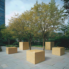 Urban park landscape design with stone cubes, trees, and modern buildings in the background. Ideal for architecture, landscaping, or urban design websites