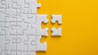 © Nicat - Flat lay of an incomplete white jigsaw puzzle on a bold yellow background, highlighting the missing piece.