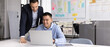 © fizkes - Diverse business professional men working at laptop together. Positive Asian manager, developer showing work process on computer to boss, supervisor, mentor, smiling, laughing. Banner shot