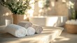 © Alena - Serene Spa: Softly rolled towels on a wooden surface, accompanied by natural decor, set the tone for a relaxing spa environment. The scene is bathed in warm light, evoking tranquility and pampering.