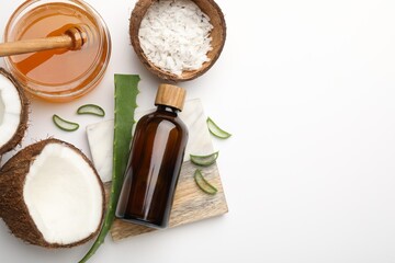 Wall Mural - hair treatment. cosmetic product, coconut, butter shavings, honey and aloe leaves on white backgroun
