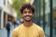 © miss irine - Smart smiling indian man portrait. Confident successful student wearing yellow shirt looking at camera. Happy businessman posing in modern office or university campus, business casual attire concept.