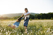 © morrowlight - Mother playing with child girl 4-5 year old in blooming chamomile meadow wearing casual dresses outdoors. Springtime. Motherhood.