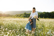 © morrowlight - Mother playing with child girl 4-5 year old in blooming chamomile meadow wearing casual dresses outdoors. Springtime. Motherhood.