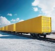 © ArtfulAura - A long line of vibrant yellow cargo containers on a train track against a bright blue sky. Efficient transportation and logistics.