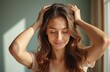 © miss irine - Young woman giving relaxing head massage at home. Promote hair growth, stimulate scalp with hands. Natural light indoors, wellness, beauty routine. Self care essential, relaxation, stress relief.