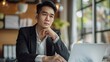 © Hamza - Asian businessman sitting and thinking analyze financial reports Business growth using laptop computer and documents, graphs, charts, investment calculators. Office business plan