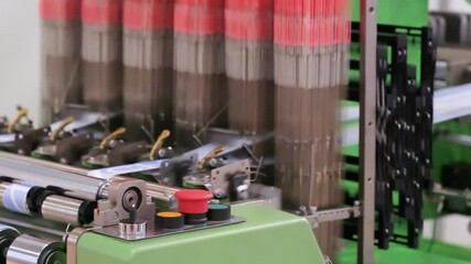 Poster - Machine is making blue fabric. The machine has a green handle