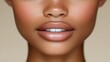 © Bandi - Close-up of woman's nude lipstick, full lips, and flawless skin.