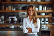 © PhotoProAD - A woman is standing in a kitchen with a smile on her face
