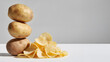 © Anoop - Whole brown potatoes paired with golden potato chips, blending earthy freshness and crisp savories in a rustic wholesome display of versatile potato goodness