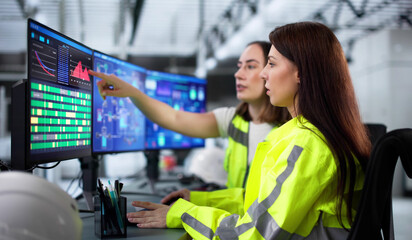 Poster - Female engineer closely monitors green energy project