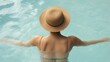 © Wannapha - Relaxed woman in a straw hat, enjoying a serene pool day, embracing tranquility and summer vibes, space for text.