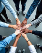 © lina - diverse group of people joining hands to show unity and collaboration