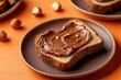 © Photique - Delicious chocolate spread on toasted bread garnished with hazelnuts.