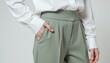 © Lightning - Stylish woman in sage green trousers and white blouse - modern professional attire