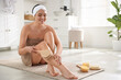© New Africa - Woman doing anti cellulite massage with brush indoors. Space for text