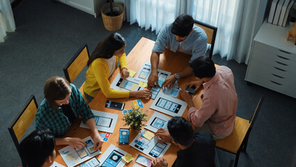 Wall Mural - top view of developer team designing ux ui design for phone interface or planning for making digital