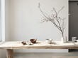 © RaksaLinggo - A wooden table displays bowls and a branch with a vase