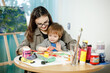 © ces - Mother and son painting together in their room