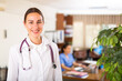 © JackF - Portrait of positive female doctor wearing uniform standing with stethoscope in modern clinic