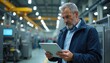 © Vadym - Serious grey-haired bearded engineer using tablet to monitor hi-tech factory automated production process. Mature male in blue jacket checks industry manufacturing line performance. Digital control,