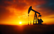 © sornram - An industrial oil pump silhouetted against a vibrant sunset, showcasing the energy sector and natural resources.