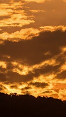 Wall Mural - breathtaking beauty of the sun rising time lapse video over a rugged mountain ridge on a cloudy morn