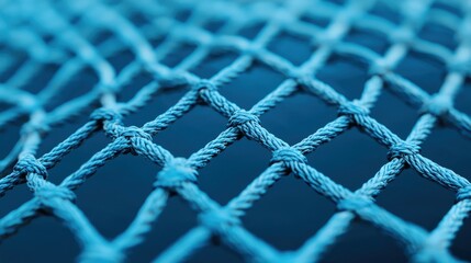 Close up of a blue rope net with a blurred background. Concept of safety, security, and connection.
