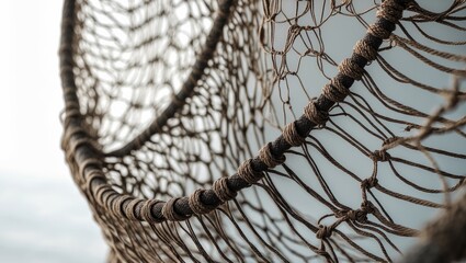 Detailed perspective of a traditional fishing net against a backdrop.