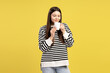 © Maria Vitkovska - Young girl enjoying aroma of hot beverage in white mug on yellow background