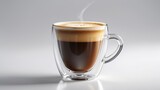 Coffee americano in a clear glass mug set against a white background. Timeless and sophisticated coffee drink.
