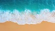 © Thamonchanok - Beach waves landscapes concept. Aerial view of turquoise ocean waves gently lapping against a sandy shore.