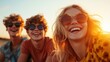©  Shomixer - Three friends wearing sunglasses capture the essence of summer while laughing and enjoying each other's company during a vibrant sunset, radiating pure joy.