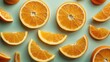 © StockKing - Fresh ripe orange slices arranged on a soft pastel blue background with varying shapes and positions creating a vibrant citrus display.