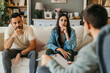 © La Famiglia - Young couple undergoing marriage counseling with psychologist taking notes